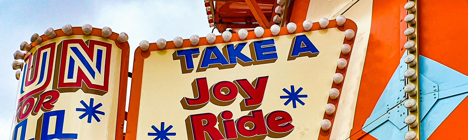 Sign on an amusement park that says “Take A Joy ride.”