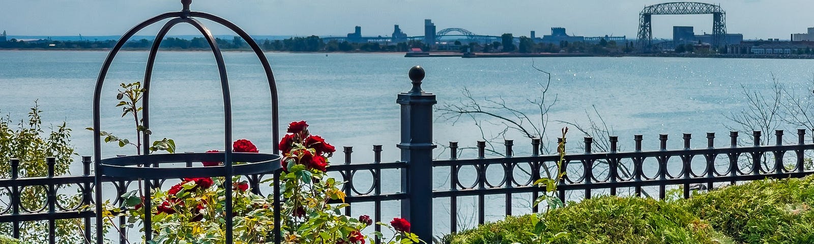 View of Canal Park and the Aerial Lift Bridge from the Duluth Rose Garden. © 2021 Randy Runtsch.
