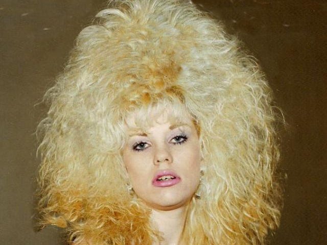 Photo of a blond woman with puffy, blond and frizzy hair.
