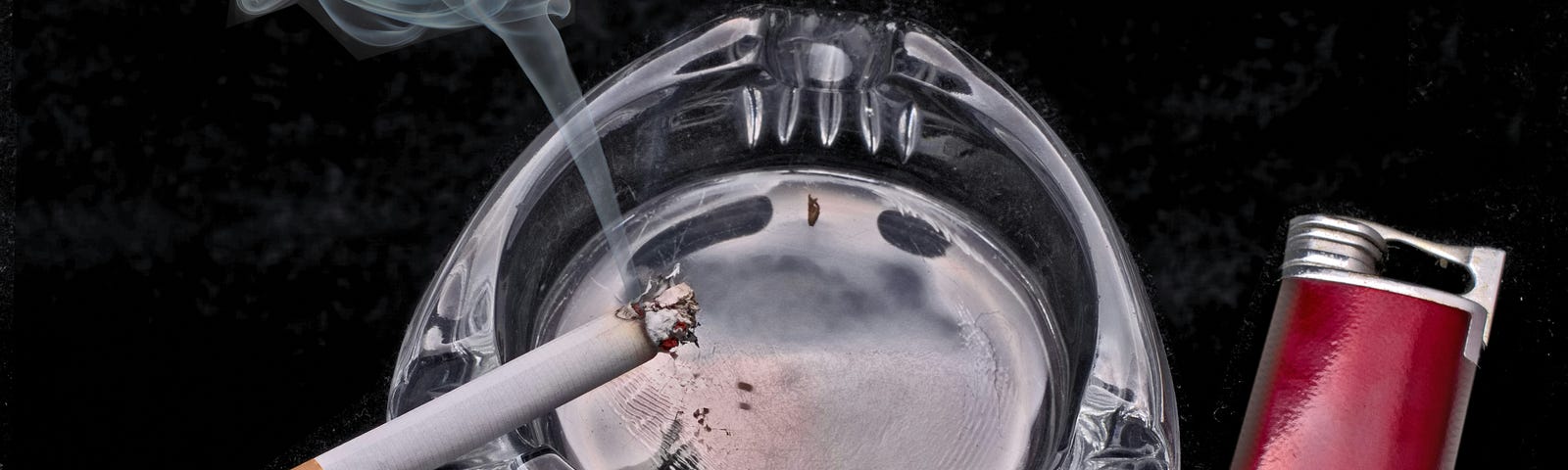 Cigarette in ashtray..