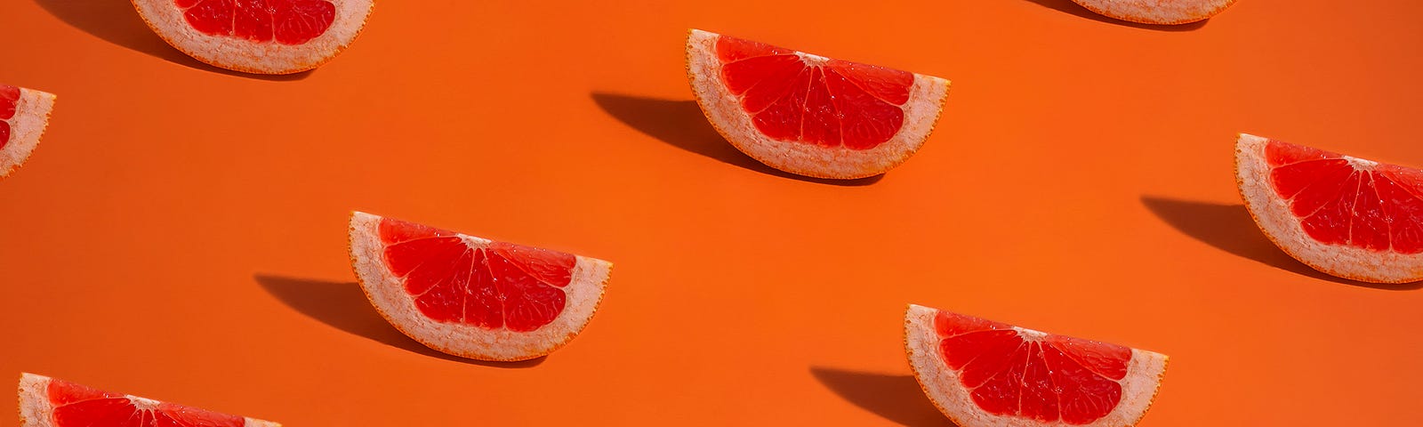 Slides of blood orange are repeated in a diagonal pattern against an orange background.
