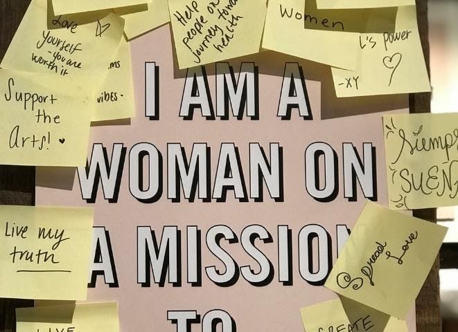 Board with the text “I am a woman on a mission to” with post-it notes describing her different missions.