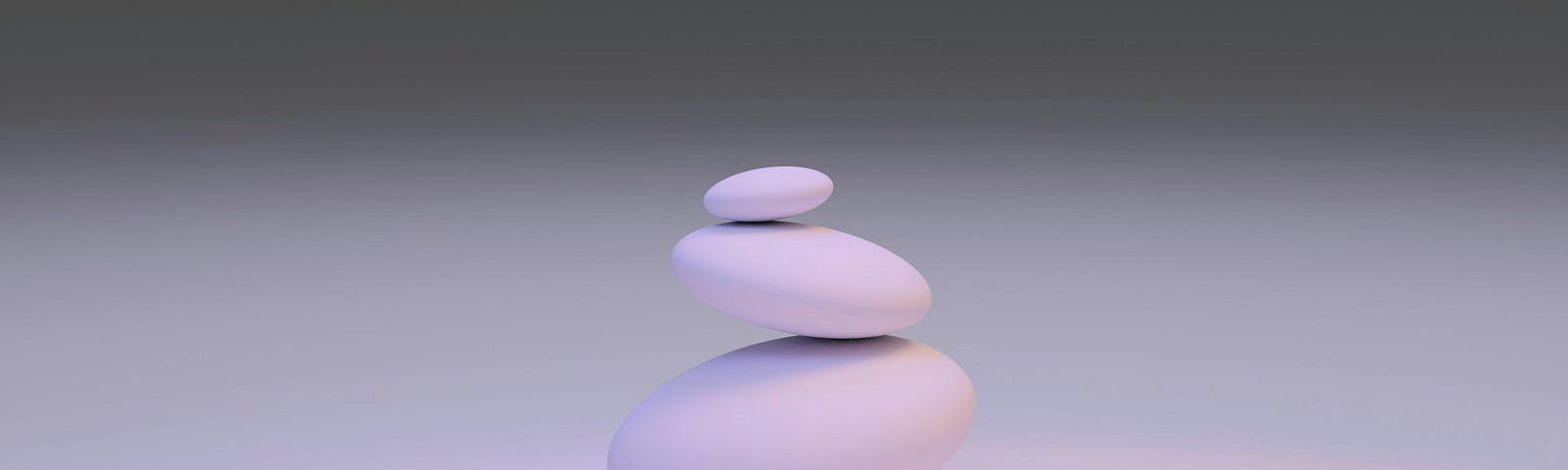 three stones of different size kept on top of other.
