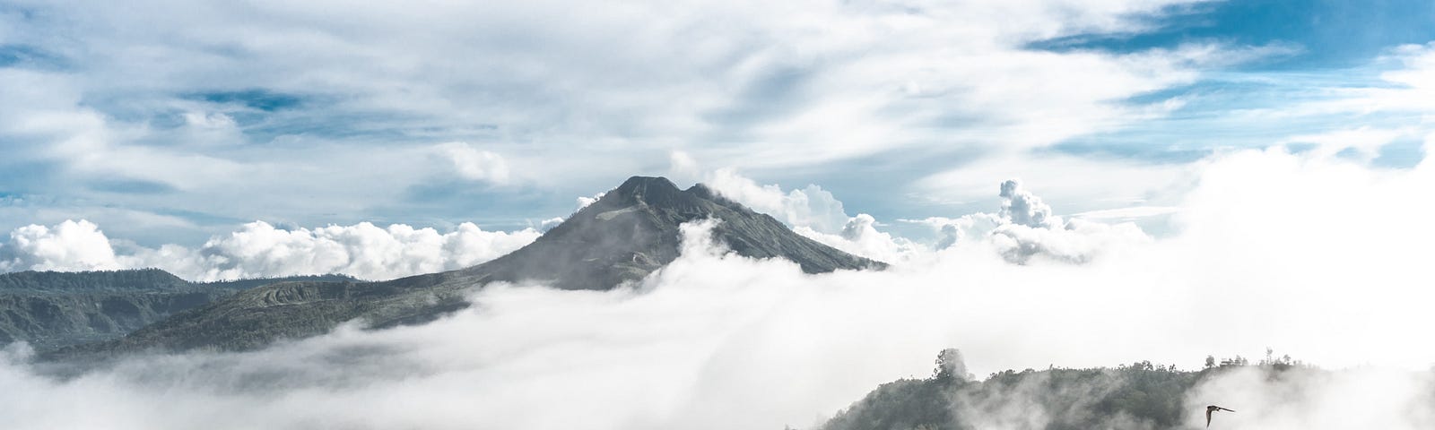 A mountain surrounded by mist and brilliant light