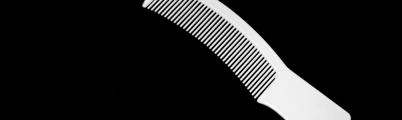 white comb with a black background