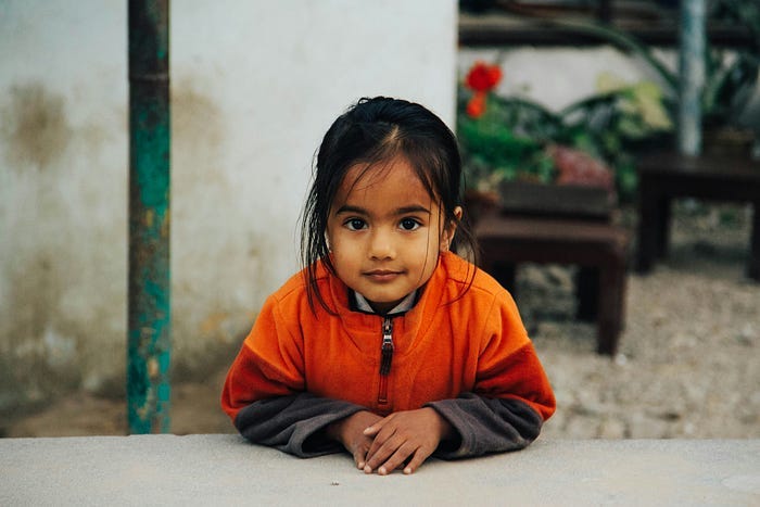 Young girl staring at the camera with interest.