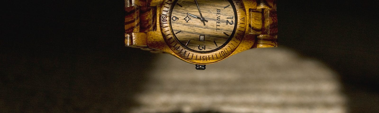 A gold-colored watch faces us as it levitates.