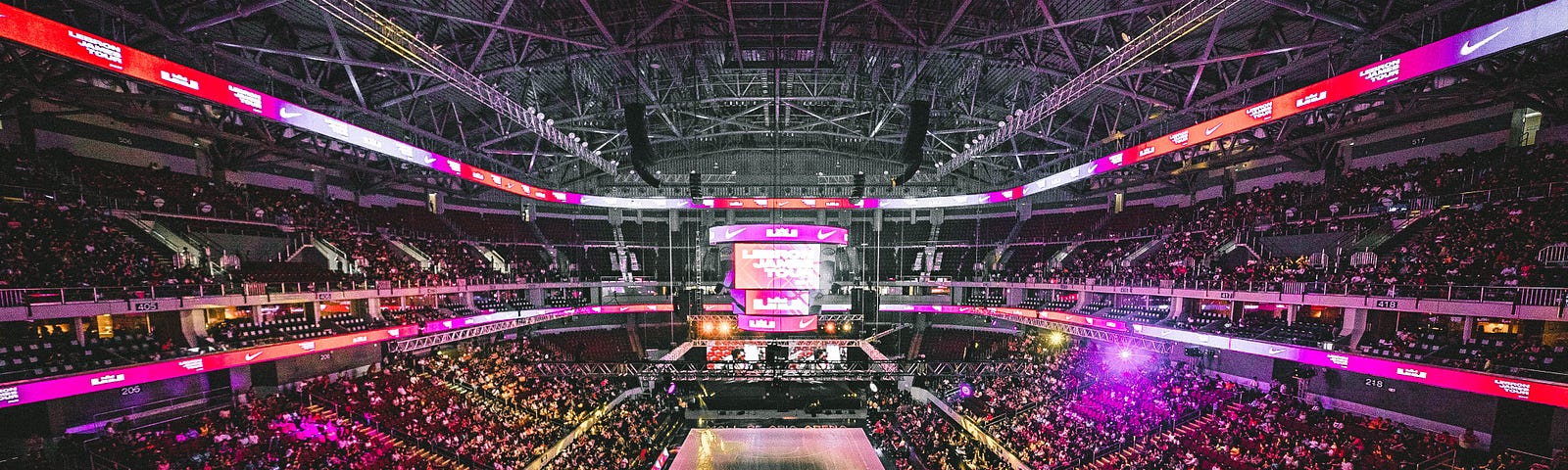 NBA stadium filled to capacity with lights blazing.