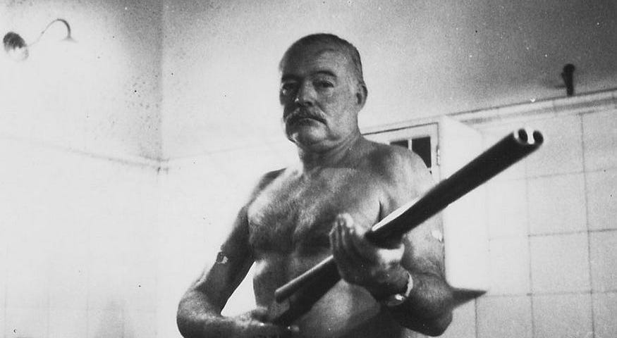 Ernest Hemingway at the Finca Vigia, Cuba. Holding a shotgun. (Source: Wikipedia Commons).