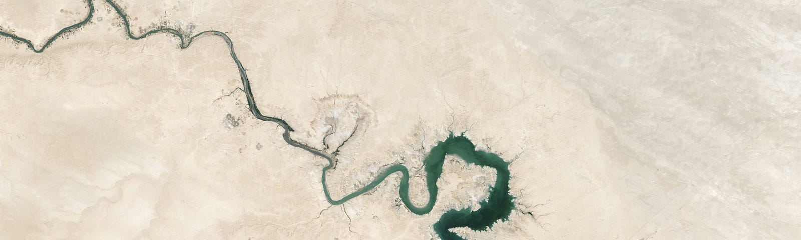 River in the desert. Air space photo. Our holy personal identity is smoke in the wind.