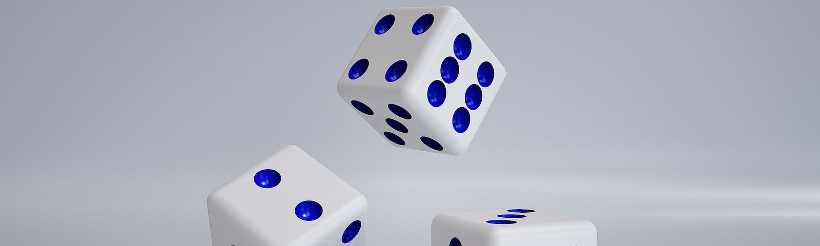 Three dice in various stages of rolling.