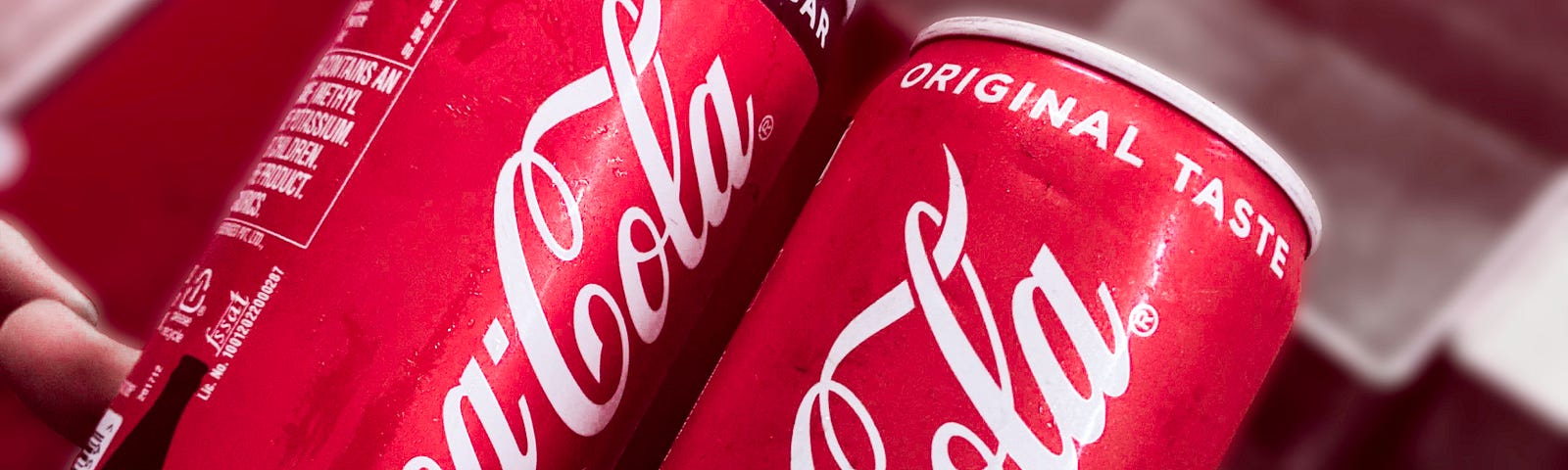 2 held up cans of Coca-cola where the left one says “no sugar” and the right one says “original taste” in apropos use for the title of this story, “Copies Are Never the Originals”.