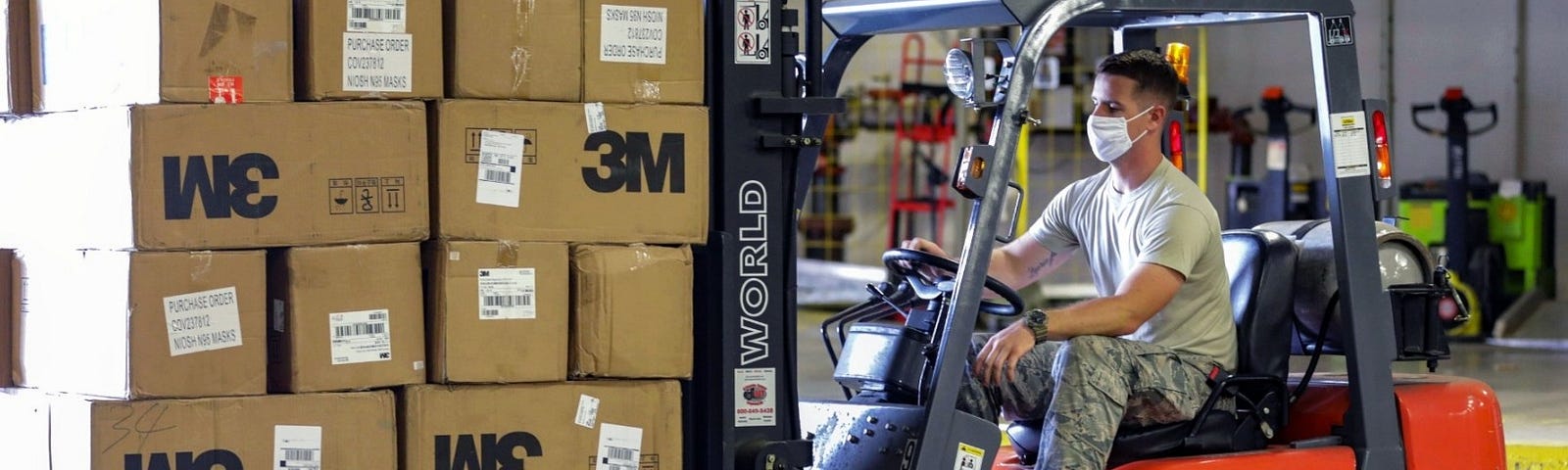 North Carolina Air National Guard Airman Staff Sgt. Jay Benton transports equipment with a fork-lift at a warehouse in western North Carolina, June 18, 2020. Photo by Sgt. Marcel Pugh/U.S. Army