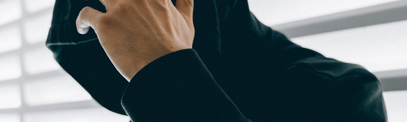 Photo of a teenager with a hoodie covering their face.