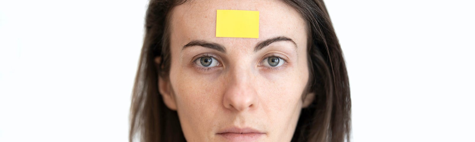 woman with yellow label on her forehead