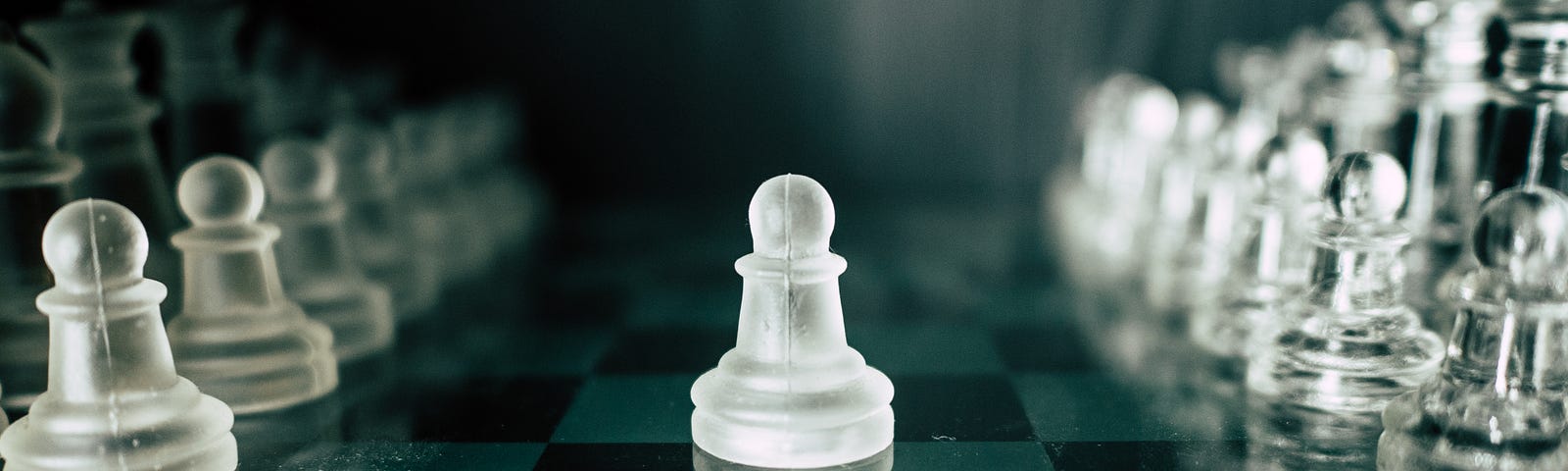 A pawn piece stands at the center of a chess board