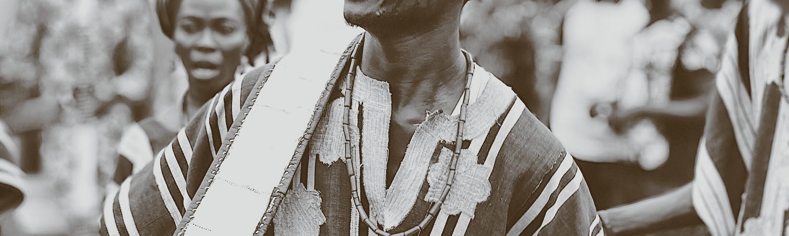 Image of a western Nigerian man playing a talking drum, small businesses need to be loud to connect in the age of distraction