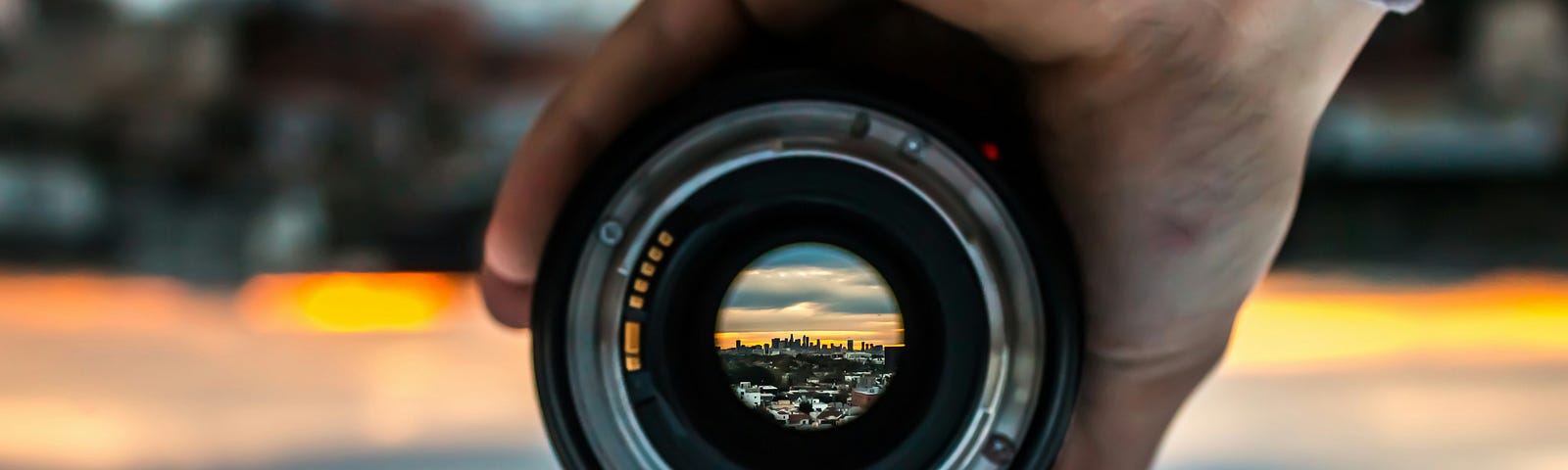 A lens of a camera focusing on the city skyline
