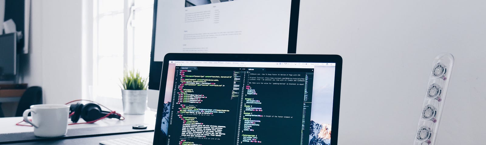 Desk with a Macbook and an iMac