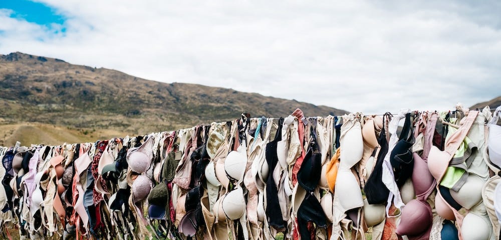 photo of thousands of bras handing on a clothes line