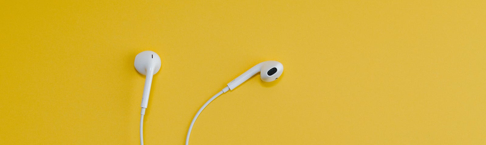 Wired earbud headphones on a yellow background