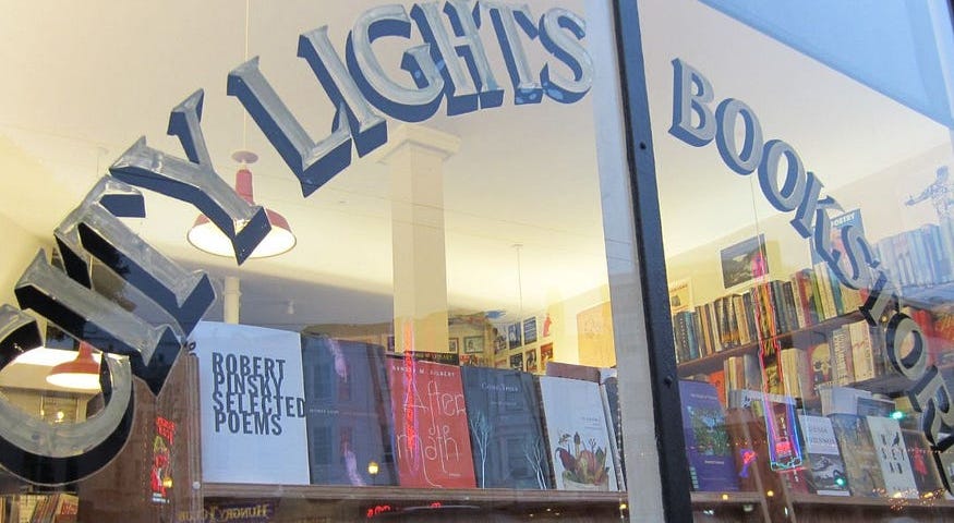 The window of a bookstore in San Francisco’s North Beach neighborhood invites readers to linger inside.