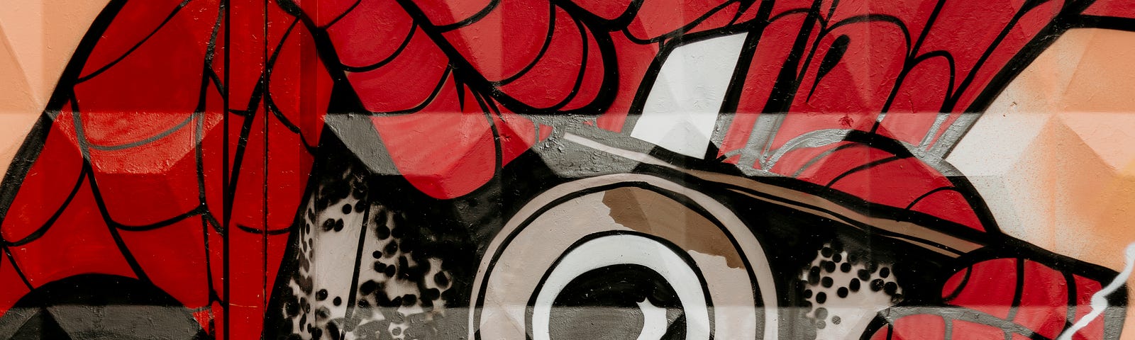 A mural of Spider-Man hanging upside-down and taking a photo with his analog camera.