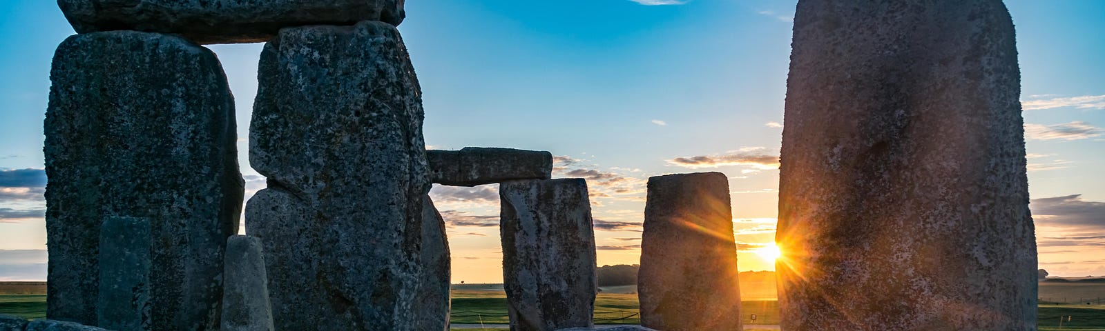 The sun sets behind Stonehenge