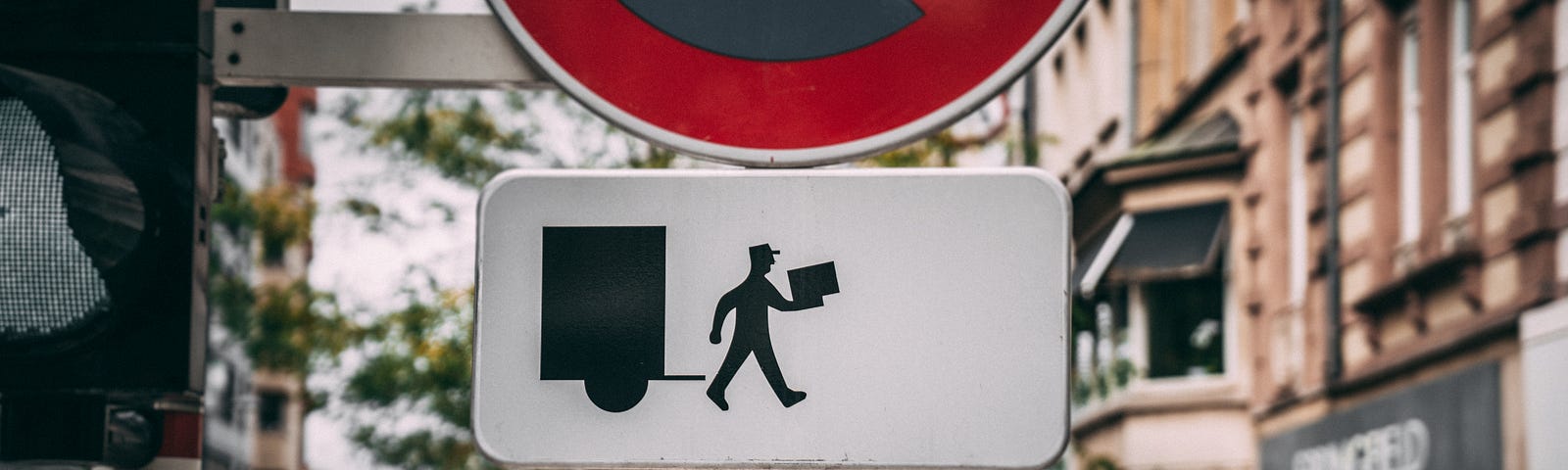 Photo of an illustrated sign of a man leaving a delivery truck with a package.