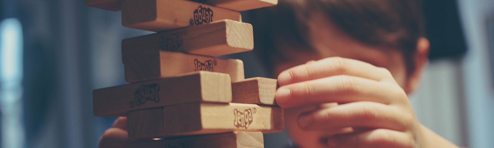 A child playing the “Jenga Tower” game