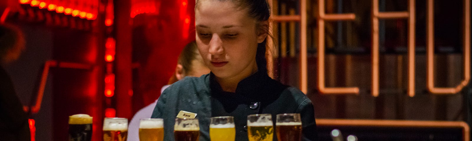 Bartender lining up glasses of beer