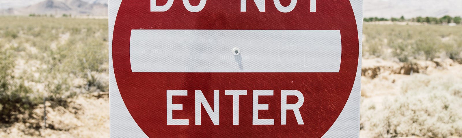 Two road signs, saying Do Not Enter and Wrong Way