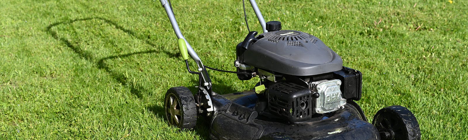 black lawn mower on green grass