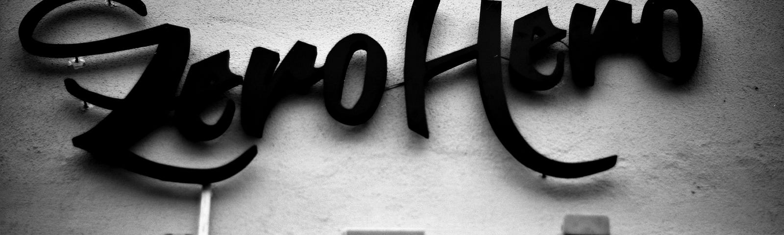 WRITING TIPS AND TRICKS Dear Writer, You Really Do Not Have to Worry When You Get Zero Claps for Your Stories There are six zeros in a million. The Image shows the words ZERO HERO in black script on what looks like a wall. It is a black and white image with the words written in black.