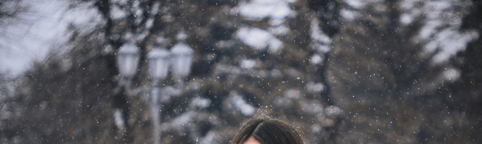 woman on snow covered bench with snow covered ground