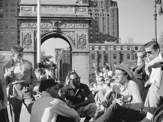 People listening to folk singer Ramblin’ Jack Elliott on a Sunday afternoon in Washington Square, Greenwich Village, 1955.