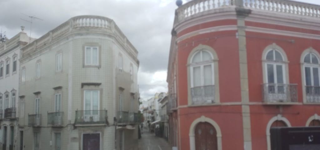 Narrow cobblestone street between two buildings