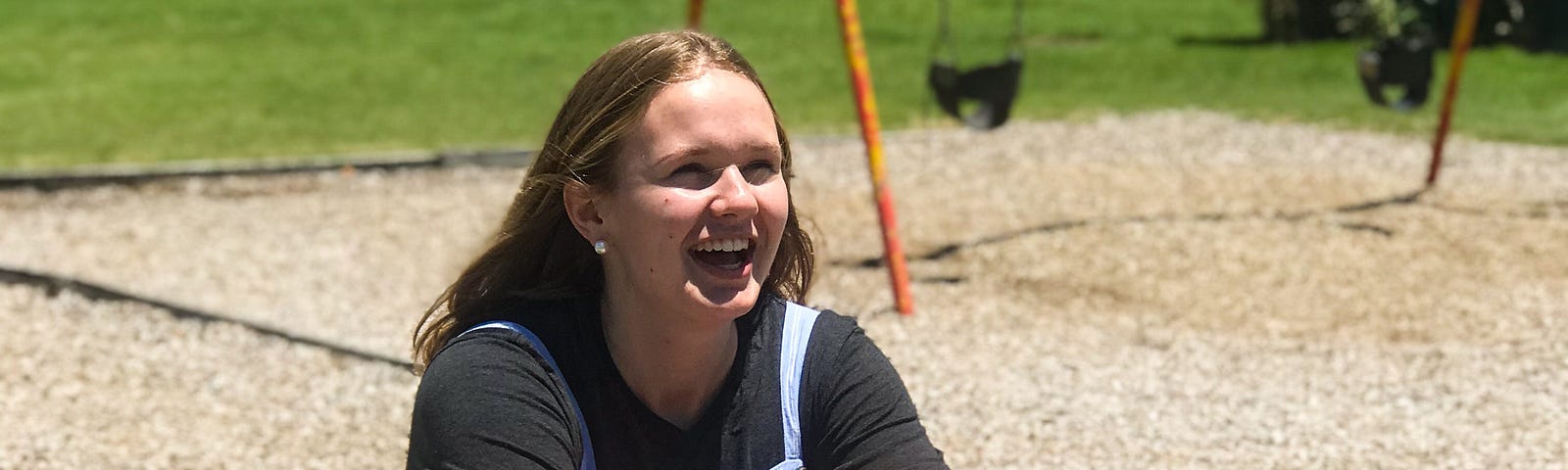 A smiling girl on a playground