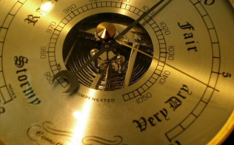 Close-up of an antique barometer showing the lettering ‘stormy’, ‘very dry’ and ‘fair’