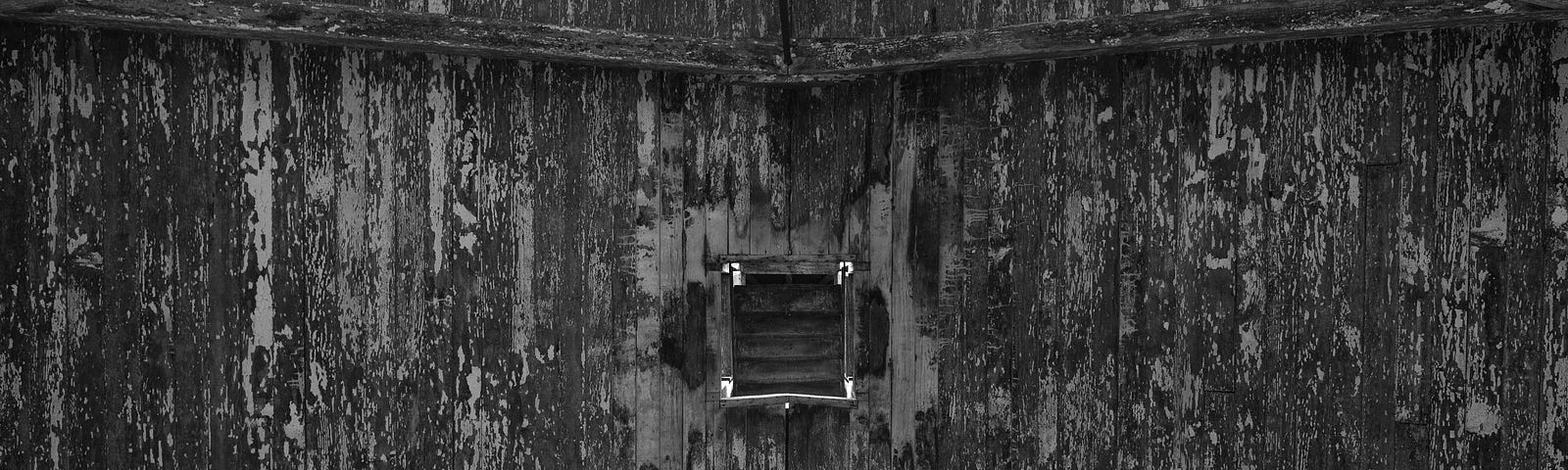 Image is the internal structure of a building, in black and grey tones. It’s meant to convey a depressing tone.