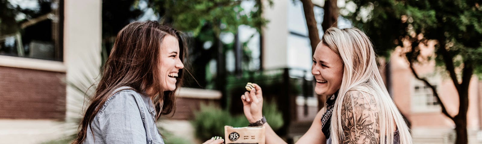 2 women laughing, eating licorice