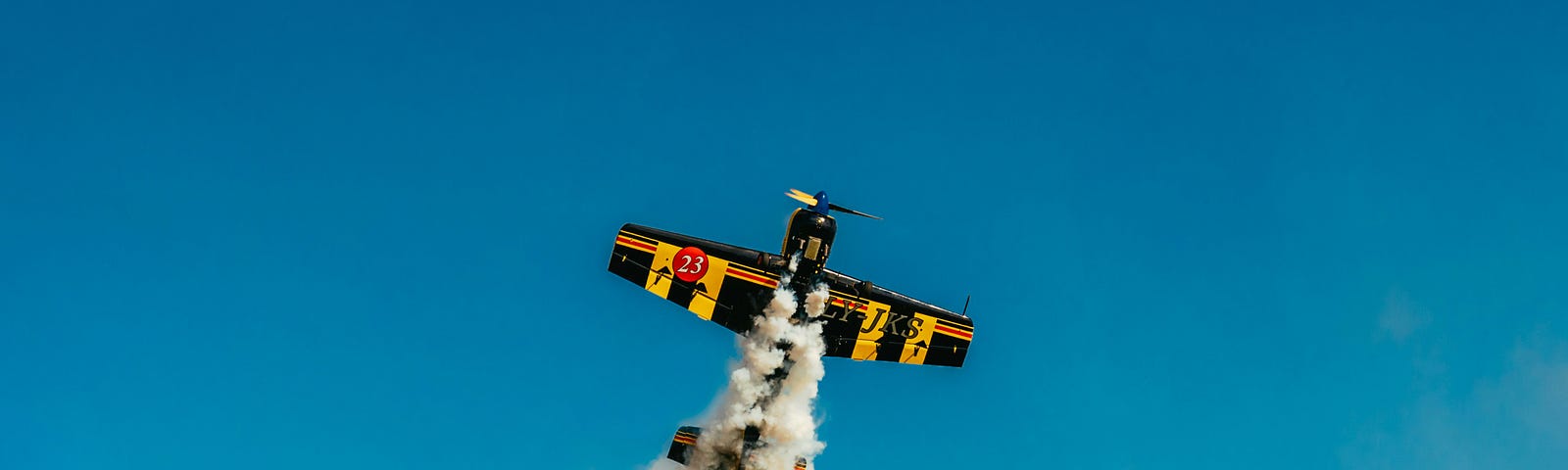 A small plane giving out smoke