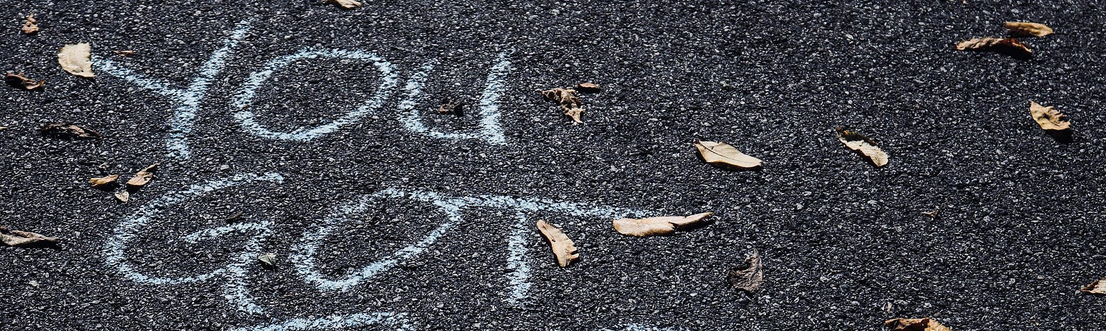 “You got this” written in chalk on asphalt.