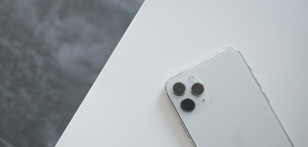 White iPhone 11 Pro on white surface table