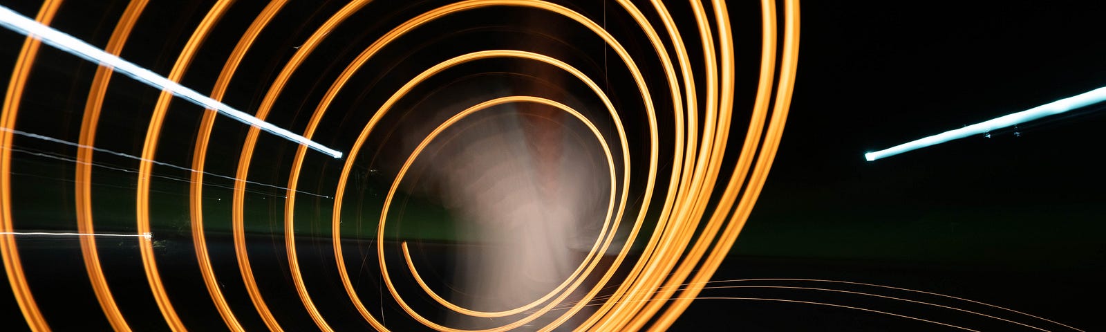 A yellow fiber optic thin cable loops as it forms the shape of a cone. There is a black background. This article explores four tips on mitigating the impact of noise on sleep.