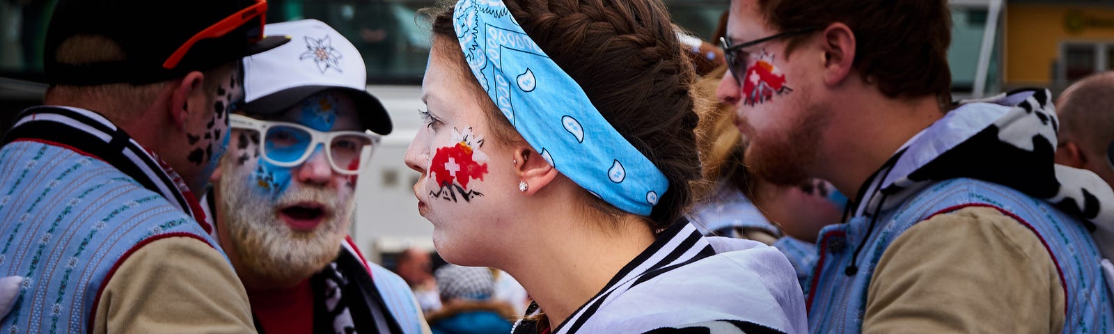 Men and woman wearing face paint outside arguing