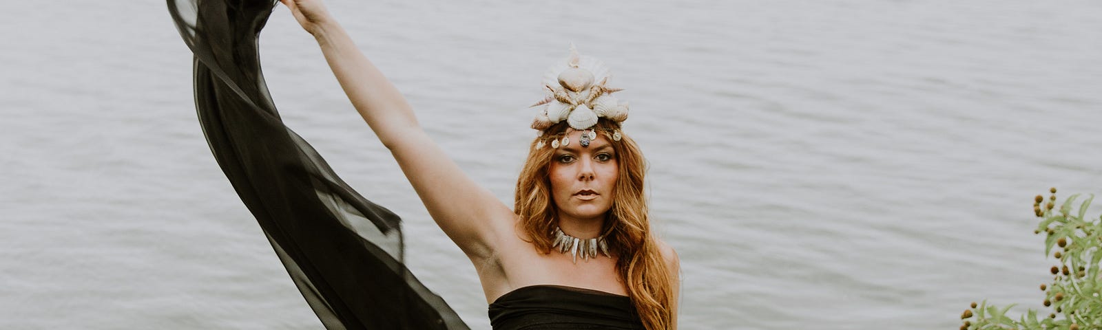 A beautiful water nymph, standing seductively by the shoreline.