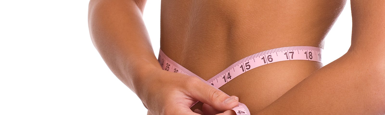 Woman measuring her waist trying to lose weight