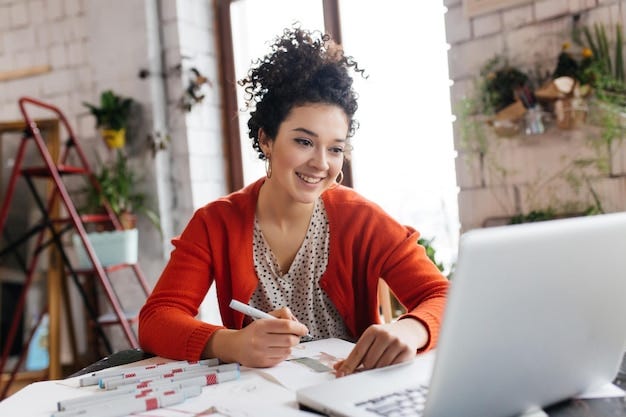 Female content writer looking at her laptop and smiling