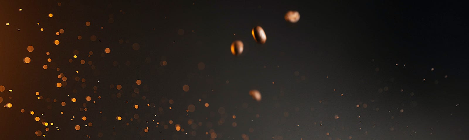 A color photo of coffee beans raining from above, splashing into a white mug of coffee. Caffeine and coffee prepare the brain to move from resting to working on tasks.